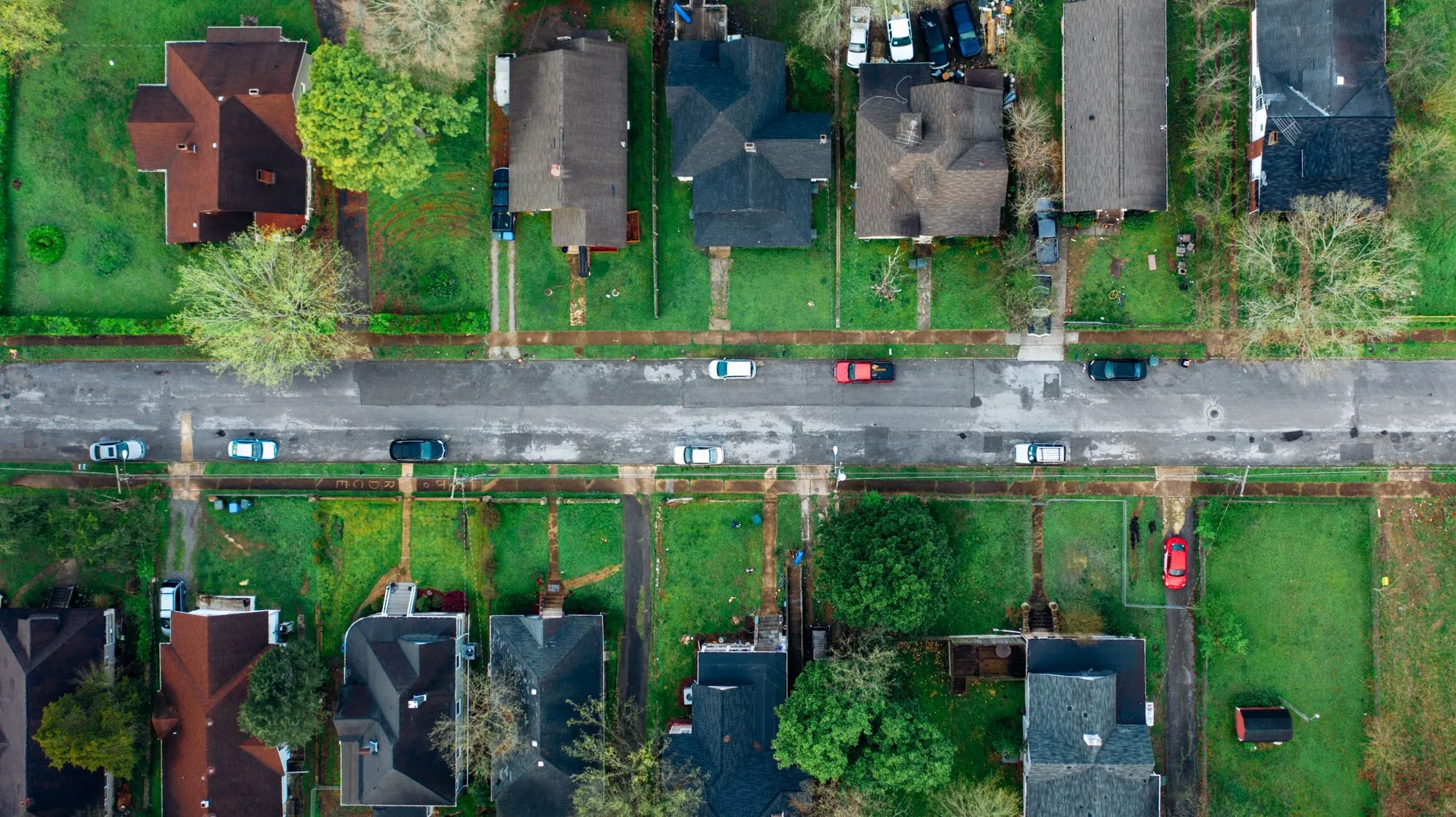 An overhead view of a residential street and its rooftops